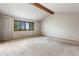 Spacious bedroom with a vaulted ceiling and scenic outdoor views from the large window at 1961 S Xenia Ct, Denver, CO 80231