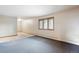 This bright bedroom has natural light, neutral paint, wood trim, and a mix of carpet and unfinished flooring at 1961 S Xenia Ct, Denver, CO 80231