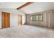 Bright bedroom with a vaulted ceiling, large window, and ensuite bathroom access at 1961 S Xenia Ct, Denver, CO 80231