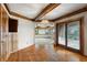 Charming dining room with hardwood floors, wood beams, and sliding doors to deck at 1961 S Xenia Ct, Denver, CO 80231