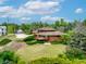 Unique brick home with a spacious yard, lush greenery and a large deck perfect for outdoor enjoyment at 1961 S Xenia Ct, Denver, CO 80231