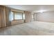 Spacious living room with neutral carpet, large windows with curtains, and ample natural light creating a bright space at 1961 S Xenia Ct, Denver, CO 80231
