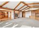 Spacious living room featuring a brick fireplace, wood beams, and built-in cabinetry at 1961 S Xenia Ct, Denver, CO 80231