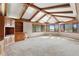 Bright living room featuring beamed vaulted ceiling, built-in shelves, and large windows at 1961 S Xenia Ct, Denver, CO 80231