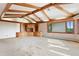 Open living room with vaulted ceiling, built-in shelves, and scenic outdoor views at 1961 S Xenia Ct, Denver, CO 80231