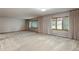 Spacious living room with neutral carpet, three large windows with curtains, and ample natural light at 1961 S Xenia Ct, Denver, CO 80231