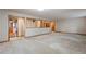 An open living space with neutral carpet, wood trim accents, and seamless transitions to other areas of the home at 1961 S Xenia Ct, Denver, CO 80231