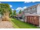 Green backyard offers a patio with an umbrella, gazebo, lush lawn, and privacy fencing at 11716 Fairplay St, Commerce City, CO 80603