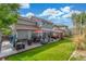 Expansive backyard features a patio with a dining area, a gazebo, a grill, and a well-maintained lawn at 11716 Fairplay St, Commerce City, CO 80603