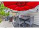 Outdoor dining area on the patio with a red umbrella and a heat lamp, creating a relaxing outdoor space at 11716 Fairplay St, Commerce City, CO 80603