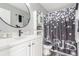 Well-lit bathroom featuring a single sink vanity, modern fixtures, and Paris themed shower curtain at 11716 Fairplay St, Commerce City, CO 80603