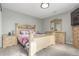 Cozy bedroom featuring a light wood frame bed, matching dresser, and neutral gray walls at 11716 Fairplay St, Commerce City, CO 80603