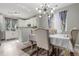 A dining area next to the kitchen with table seating 6, featuring luxury vinyl plank and designer curtains at 11716 Fairplay St, Commerce City, CO 80603