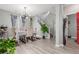 The dining room has a modern chandelier and gray walls, complemented by luxury vinyl plank flooring at 11716 Fairplay St, Commerce City, CO 80603