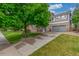 Two-story home with brick and siding exterior, complemented by a mature shade tree at 11716 Fairplay St, Commerce City, CO 80603