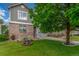 Charming home featuring a well-manicured lawn, mature shade tree and classic brick facade at 11716 Fairplay St, Commerce City, CO 80603