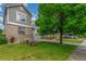 Beautiful home featuring a lush green lawn, mature tree, and a classic brick elevation at 11716 Fairplay St, Commerce City, CO 80603