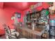 The garage features a custom-built wooden bar with a unique design and ample storage for drinks and accessories at 11716 Fairplay St, Commerce City, CO 80603