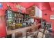 The garage features a custom-built wooden bar with a unique design and ample space for drinks and accessories at 11716 Fairplay St, Commerce City, CO 80603