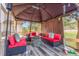 Relax in this covered outdoor patio area featuring comfortable seating and a cozy fire pit, perfect for gatherings at 11716 Fairplay St, Commerce City, CO 80603