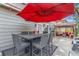 Inviting patio with outdoor seating and red umbrella, perfect for relaxing and entertaining guests at 11716 Fairplay St, Commerce City, CO 80603