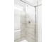 Modern tiled shower features a glass door and built in shelf, combining style and functionality for a luxurious experience at 5099 S Robb St, Littleton, CO 80127