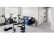 Inviting bedroom features a comfortable couch, exercise bike and neutral color palette at 5099 S Robb St, Littleton, CO 80127