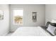 A cozy bedroom featuring neutral tones, a decorative wall hanging, and a comfortable bed with soft linens at 5099 S Robb St, Littleton, CO 80127