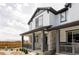 Charming two-story home with stone accents and a covered porch, offering curb appeal and outdoor living space at 5099 S Robb St, Littleton, CO 80127