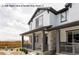 Charming two-story home featuring a welcoming front porch with stone accents and elegant gray trim at 5099 S Robb St, Littleton, CO 80127