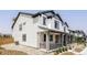 Beautifully designed home with a welcoming porch, stone accents, and neutral siding at 5099 S Robb St, Littleton, CO 80127
