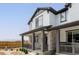 Charming two-story home featuring a welcoming front porch with stone accents and elegant gray trim at 5099 S Robb St, Littleton, CO 80127