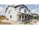 Stylish two-story home with white siding, dark trim, and a welcoming covered porch, perfect for relaxing outdoors at 5099 S Robb St, Littleton, CO 80127