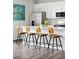 Modern kitchen island with seating, stainless steel appliances and light countertops, perfect for entertaining and Gathering meals at 5099 S Robb St, Littleton, CO 80127