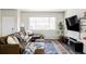 Cozy living room features a plush sectional sofa, large window, and modern decor, creating a comfortable space at 5099 S Robb St, Littleton, CO 80127