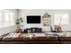 Relaxing living room showcasing brown leather sectional, entertainment center and stylish decor at 5099 S Robb St, Littleton, CO 80127