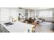 Open floor plan with seamless flow from kitchen to living room, ideal for entertaining and everyday living at 5099 S Robb St, Littleton, CO 80127