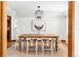 Bright dining room with a farmhouse table, white chairs, and a statement light fixture at 5451 S Zinnia Ct, Littleton, CO 80127