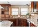 Spacious kitchen with granite countertops and wooden cabinets at 5451 S Zinnia Ct, Littleton, CO 80127