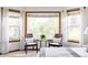 Main bedroom featuring a bay window and sitting area with two chairs at 5451 S Zinnia Ct, Littleton, CO 80127