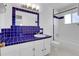 Bathroom with blue tile, white vanity, and bathtub at 6250 S Windermere St, Littleton, CO 80120