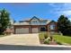 Beautiful two-story brick home featuring an attached two-car garage and a professionally landscaped front yard at 6577 Esperanza Dr, Castle Pines, CO 80108