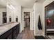Bathroom featuring double sinks, granite countertop, walk-in closet access, and glass enclosed shower at 5358 Ventura St, Denver, CO 80249