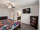 Spacious bedroom with en-suite bathroom access and a mounted TV at 5358 Ventura St, Denver, CO 80249