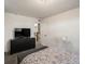 This bedroom has neutral walls, soft carpet, and a large TV; perfect for relaxation at 5358 Ventura St, Denver, CO 80249
