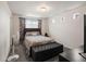 Cozy bedroom featuring plush carpeting, storage ottoman, and a sunlit window at 5358 Ventura St, Denver, CO 80249