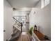 Inviting entryway featuring wood floors, a staircase, and a view into the spacious living area of the home at 5358 Ventura St, Denver, CO 80249