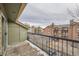 Balcony view of the parking lot between the condo buildings. Railing in the foreground at 4899 S Dudley St # 17G, Littleton, CO 80123