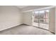 Carpeted bedroom with sliding glass doors leading to a deck at 4899 S Dudley St # 17G, Littleton, CO 80123