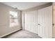 Carpeted bedroom features a bright window and closet with sliding doors at 4899 S Dudley St # 17G, Littleton, CO 80123